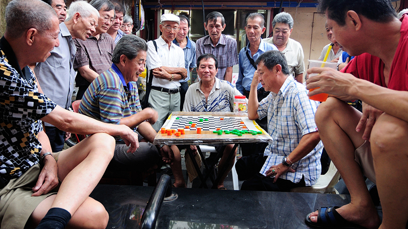 A group of senior citizens playing checkers